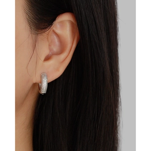 Detailed side view of silver hoop earrings with pavé set cubic zirconia stones