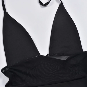 Detail of black halter neck mesh dress with sheer patchwork and hollow out design