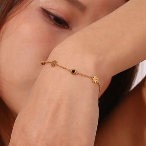 Elegant 18K gold plated stainless steel bracelet with black and white floral motifs