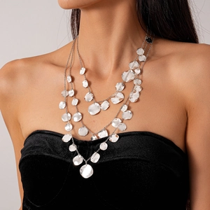Detail of silver layered necklace with hammered disc pendants on black velvet top
