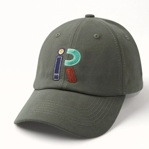 Detailed view of dark green baseball cap with high-quality colorful iR letter embroidery