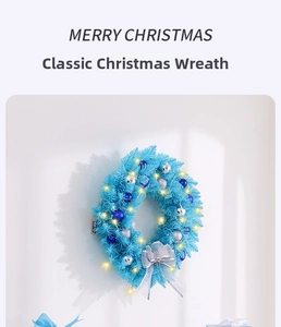 Close-up of blue Christmas wreath with silver ornaments and warm LED fairy lights