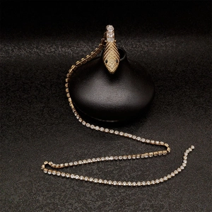 Detailed macro view of gold serpent pendant necklace with shimmering diamond accents