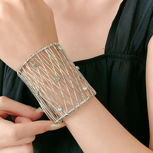 Detail of silver mesh bracelet with sparkling rhinestones worn on a female wrist