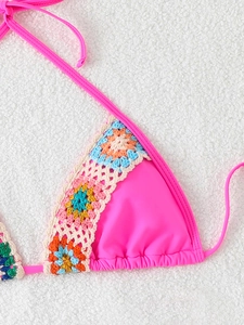 Detail of rose pink bikini top featuring colorful handmade crochet flower embroidery trim