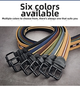 Close-up of multi-colored striped canvas belts with black leather ends and matte metal buckles