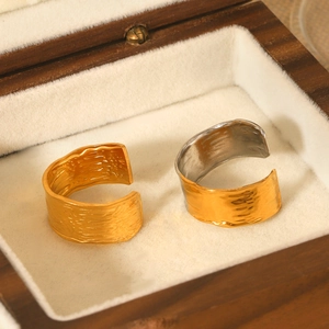 Detail of 18K gold plated stainless steel rings with hammer texture in a jewelry box