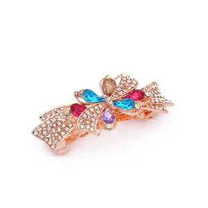 Detail of rose gold bow hair clip featuring colorful teardrop crystals and sparkling rhinestones