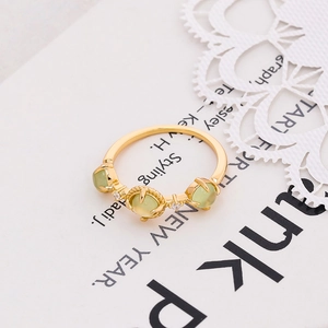 Detail of 925 sterling silver gold plated ring with three green prehnite gemstones