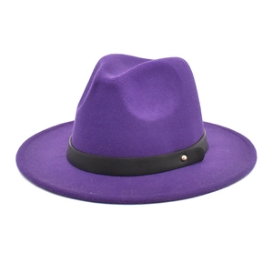 Detail of dark purple wool fedora hat featuring flat wide brim and black leather belt accent