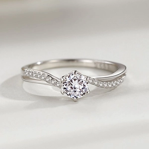 Luxurious S925 silver ring featuring a round brilliant cut solitaire with twisted pavé band