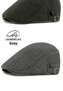 Detail view of herringbone flat caps in dark green and gray with adjustable metal buckles