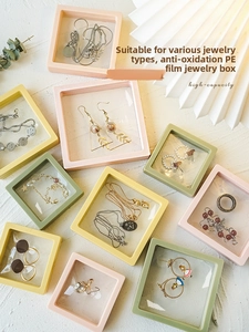 Macro detail of anti-oxidation PE film jewelry boxes in pink, yellow, and mint colors