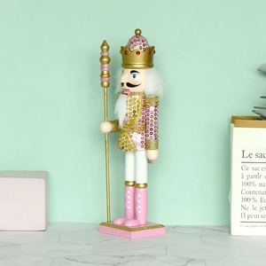 Pink sequined wooden nutcracker king 30cm Christmas decoration on light surface