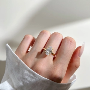 Close-up of S925 sterling silver ring with oval-cut cubic zirconia and gold finish