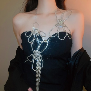 Close-up of silver rhinestone body chain with flower design and elegant crystal tassels