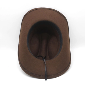 Detail view of the brown felt cowboy hat interior with black sweatband and chin strap