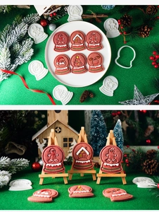 Christmas snow globe cookie molds and frosted ginger biscuits on a festive green background