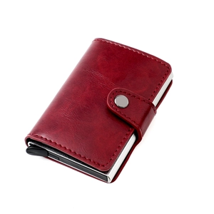 Detail of burgundy leather RFID blocking wallet showing metal card slot and pop-up mechanism