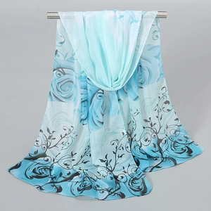 Detail showing blue rose floral print on lightweight semi-transparent chiffon scarf