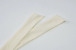 Detailed close-up of ribbed knit fabric texture in cream white for summer tank top