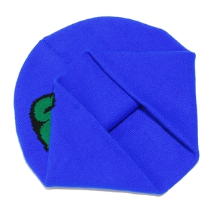 Detailed view of electric blue knitted beanie with a pixelated dinosaur-style pattern