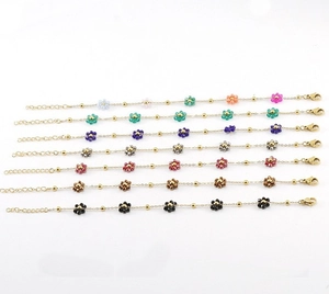 Detailed flat lay of colorful beaded flower charms on elegant gold stainless steel bracelets