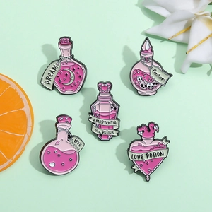Detail of five pink enamel potion pins featuring moon, heart, and magic bottle designs