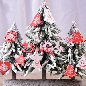Christmas wooden ornament set with red and white star, heart, and reindeer on a tree