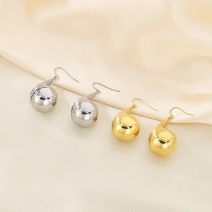 Minimalist stainless steel water drop earrings in gold and silver finish on silk fabric