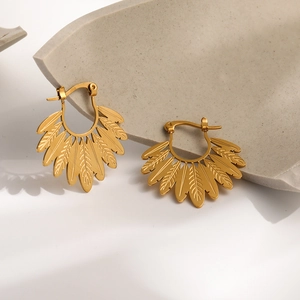 Ethnic style golden leaf fan earrings with intricate feather details on stone