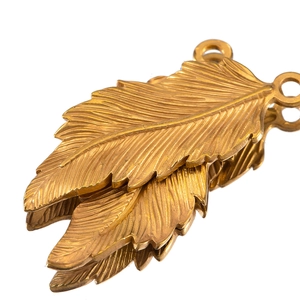 Detailed macro view of 18k gold plated stainless steel feather pendants for DIY jewelry