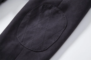 Detailed macro view of black quilted diamond stitching and twill cotton fabric on coat