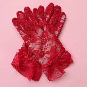Close-up of elegant red lace gloves featuring delicate floral mesh and ruffled wrist edges