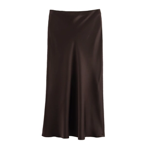 Detail of a chocolate brown satin midi skirt showing smooth silk texture on white background