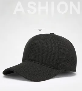 Detail of black winter baseball cap with mountain embroidery and knitted texture