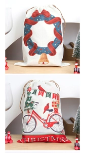 Detailed view of linen Christmas drawstring gift bags with festive wreath and bicycle prints