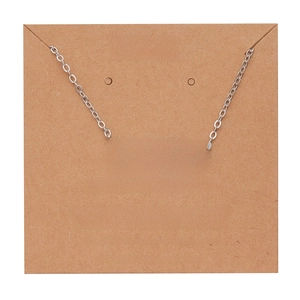 Detail view of silver Libra zodiac necklace on brown kraft card with character traits