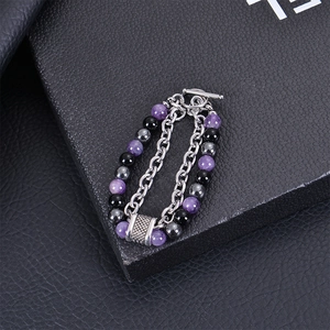 Detail of double-layer beaded bracelet with purple tiger eye stones and silver toggle clasp