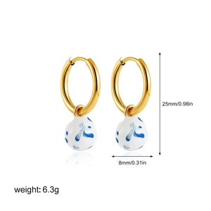 Detail view of 18K gold earrings with blue pattern porcelain drop and size measurements