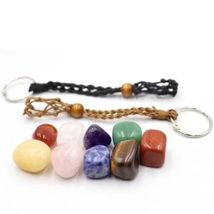Macro detail of braided mesh keychains with colorful assorted natural crystals and yoga stones