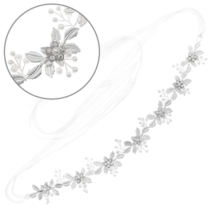 Elegant bridal hairband with silver leaves, pearls and rhinestones on white background