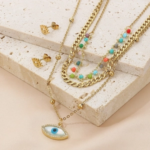 Bohemian gold layered necklace with evil eye pendant and matching stud earrings set