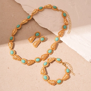 Vintage gold necklace bracelet and earrings set with turquoise stones and shell texture