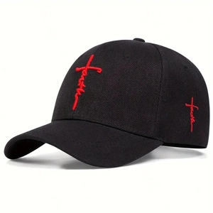 Detail of red faith embroidery and cross on black cotton baseball cap fabric