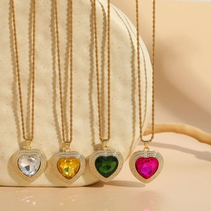 Detail of heart-shaped zircon pendants with colorful crystals on gold twist chains