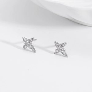 Detailed macro view of S925 sterling silver four-point star earrings with white zircons
