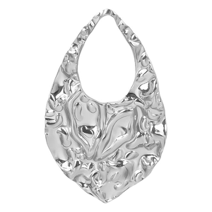 Macro shot of silver hammer-textured teardrop charm made of 304 stainless steel