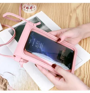 Pink PU leather crossbody phone bag with transparent touch screen window on wooden table