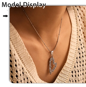 Detail of silver heart-shaped hollow pendant on a fine bead chain necklace for women